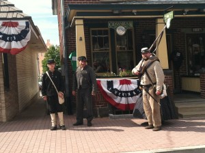 People in the town are dressed up in Union and Confederate outfits all over the place